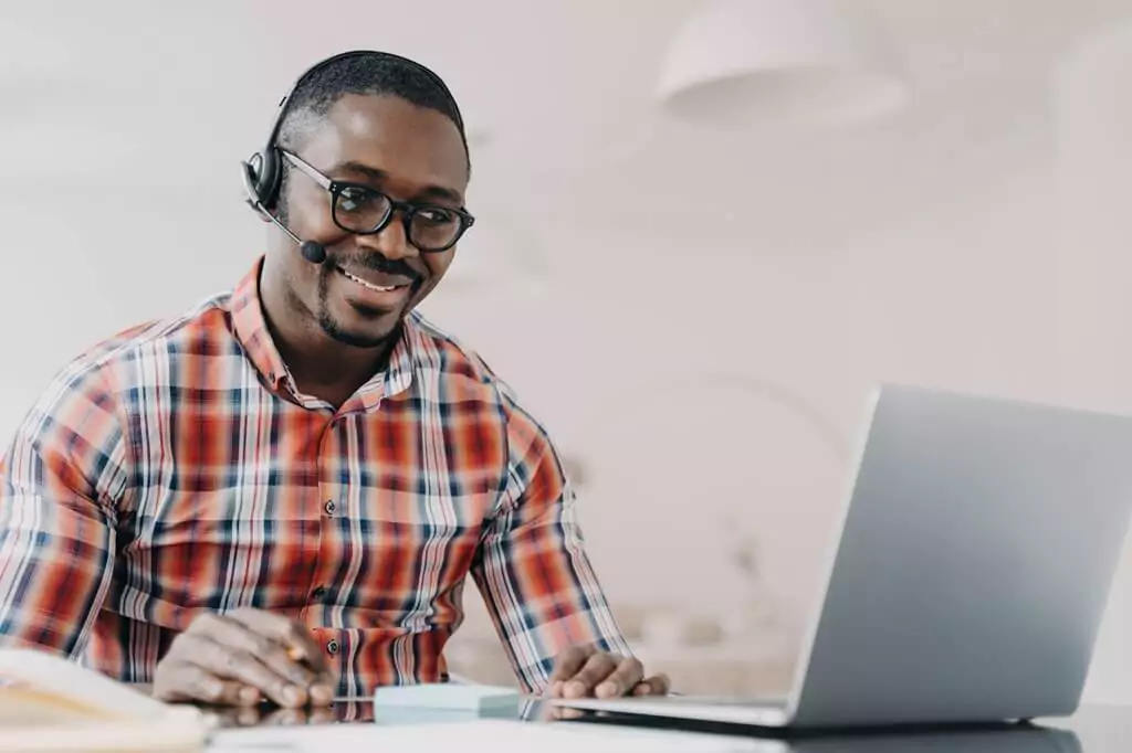 vendedor com fone em conversa com alguém pelo computador
